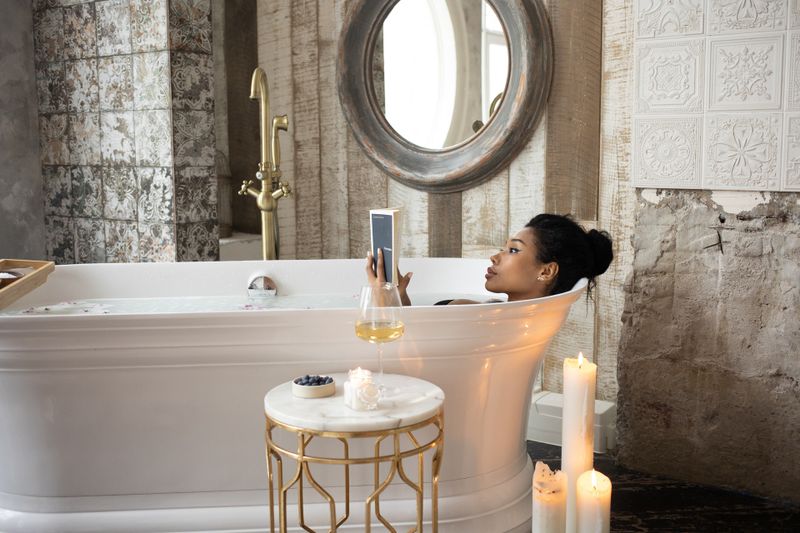 woman in a bathtub reading a book